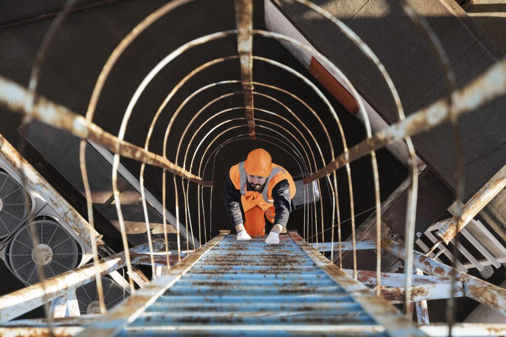 worker climbing a ladder for mep works