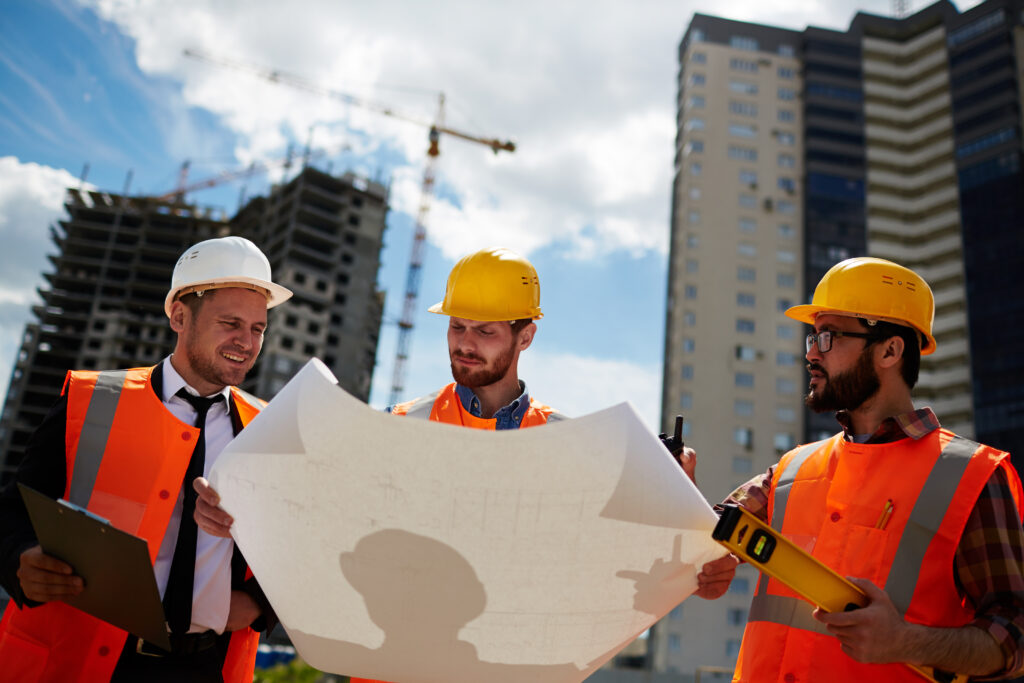 A UAE construction/business planning image with managers + workers together